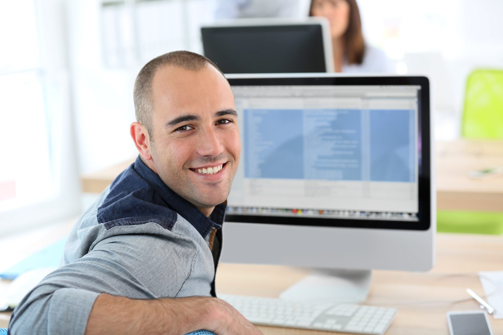 Portrait of student in front of desktop computer PROXESS